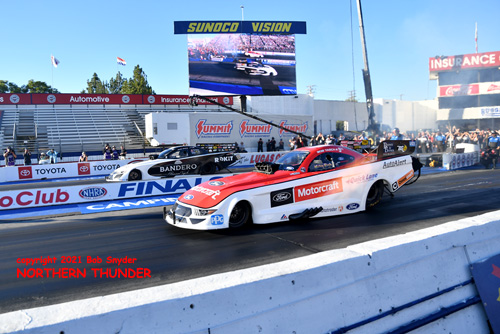 Bob Tasca III (near lane) vs Alexis DeJoria 
(far lane)